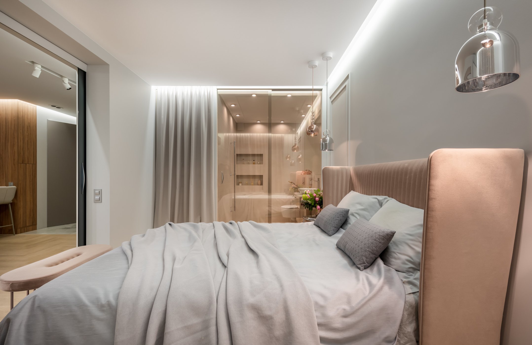 Apartment interior with bed under lamp